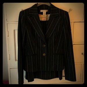 Black pinstriped skirt suit.